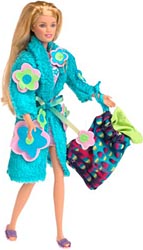 Blonde Pajama Fun Skipper wearing a turquoise robe with large flower appliqués and purple slippers, holding a colorful patterned bag.