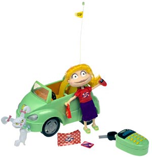 Angelica in a red top and purple skirt beside a green convertible, a multi-button controller, white cat and outing accessories.
